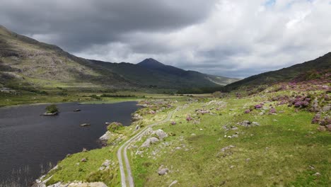 view over black waters of a valley lake surrounded by mountains