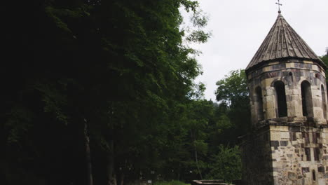 mtsvane monastery with church and bell tower in deep woods of georgia