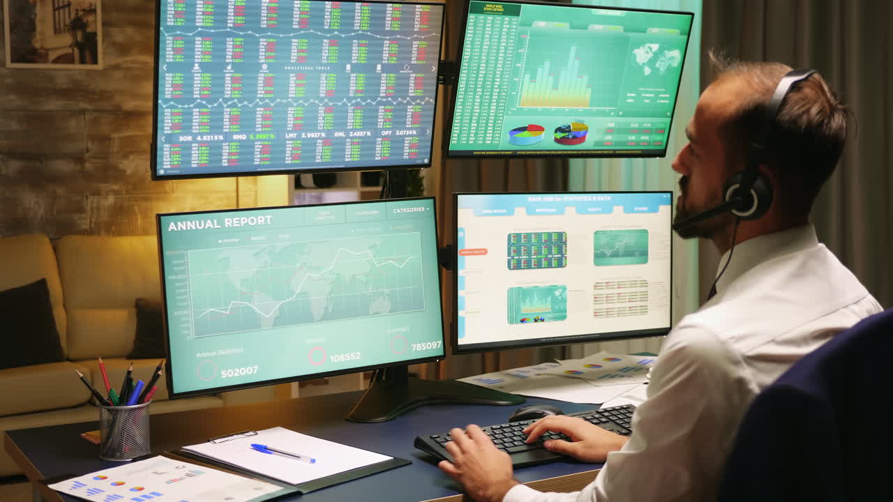 Back view of stock market broker looking at graphs