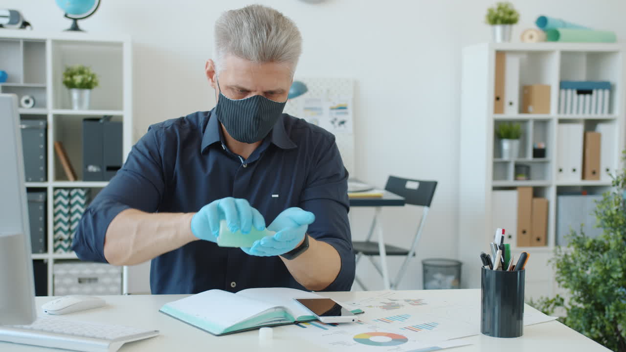 Businessperson Wearing Mask and Gloves in Office