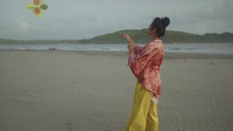 on a breezy beach, a young asian adult with a cool contemporary outfit and a unique hairstyle explores the thrill of flying her kite