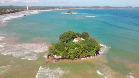 aerial shot of taprobane island at weligama, sri lanka, surrounded by clear ocean water