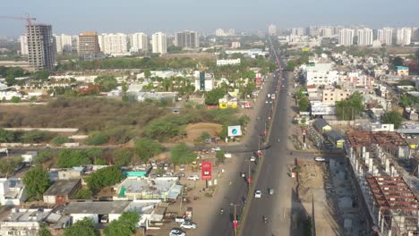 aerial panorama of an indian city with a long road and urban development