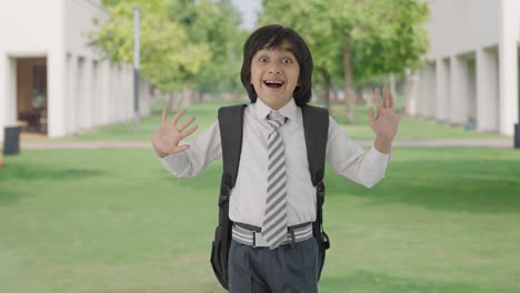 Happy-Indian-school-boy-saying-Hi-to-the-camera