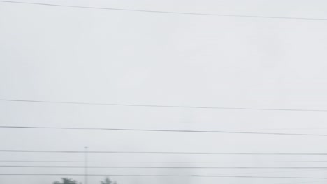 blurred power lines against a cloudy sky