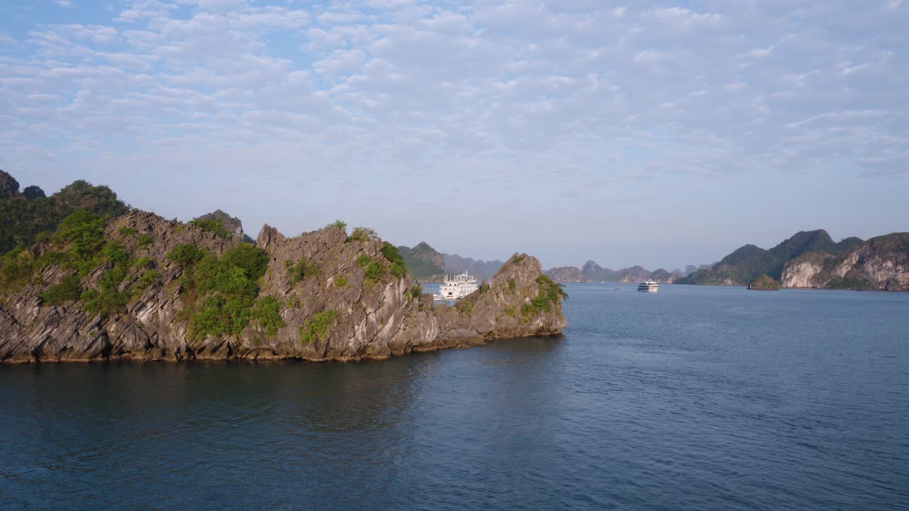 Karst Limestone Mountains in Ha Long Bay Waters with a Distant View of Cruise Tour Ships, Vietnam