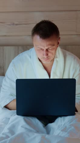 late night working session in cozy bedroom with a laptop