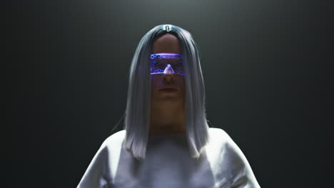 digital vr glasses girl posing in light closeup. beautiful futuristic player