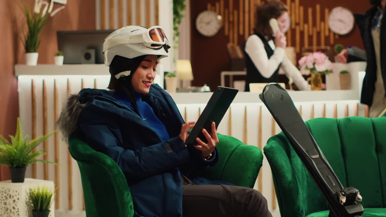 Woman navigating on tablet in lobby