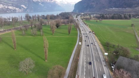 swiss highway cuts through pastoral landscape - aerial fly-over