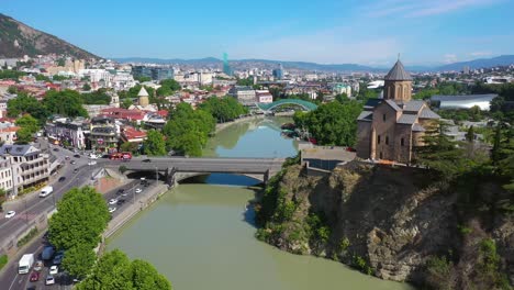 aerial shot of tbilisi city, river kura and metekhi church in georgia