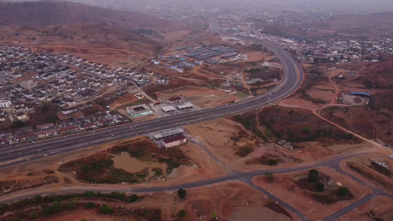 Beautiful aerial of a long highway running along the city of Abuja, Nigeria