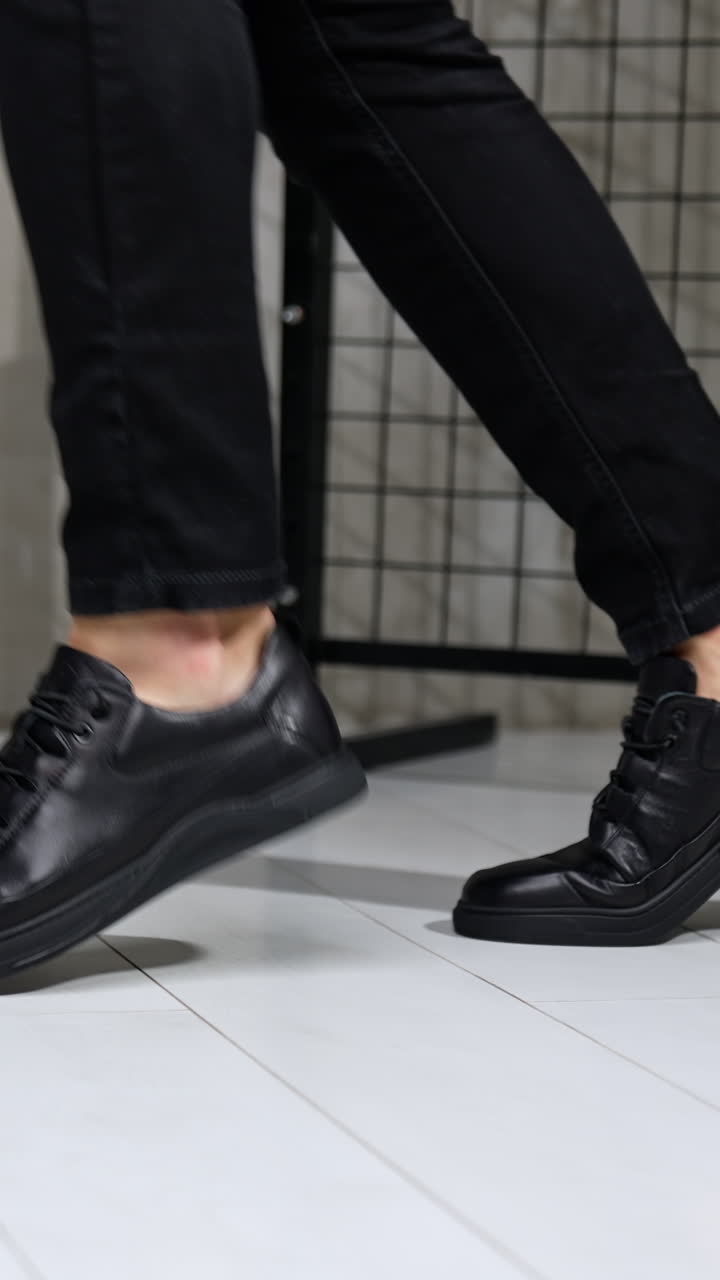 Closeup of Stylish Black Leather Sneakers on a Man's Feet