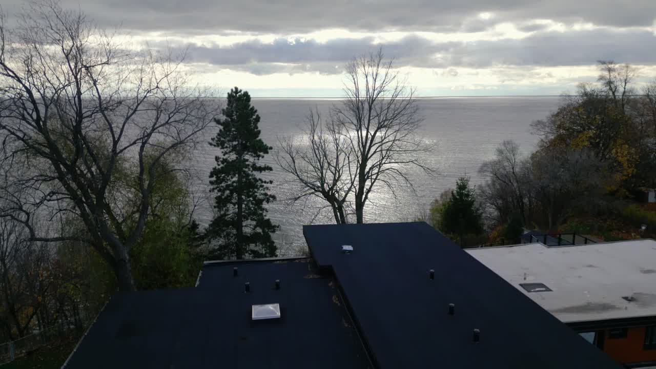 A dusk aerial ascend of a modern house with sleek architecture under soft lighting, creating a serene ambiance