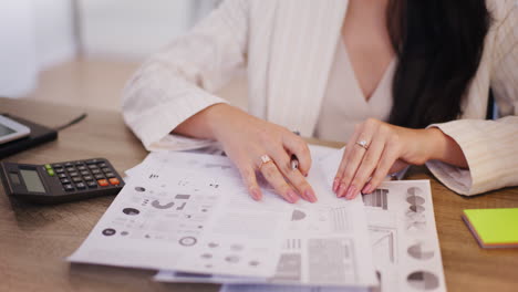 enterprising businesswoman analyzes financial report and company documents in office