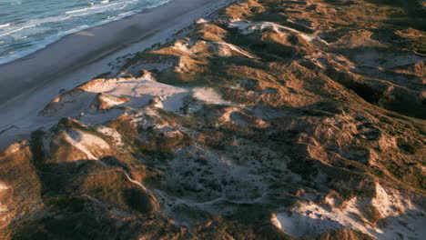 Late-afternoon-sun-casting-shadows-over-Denmark's-coastal-dunes