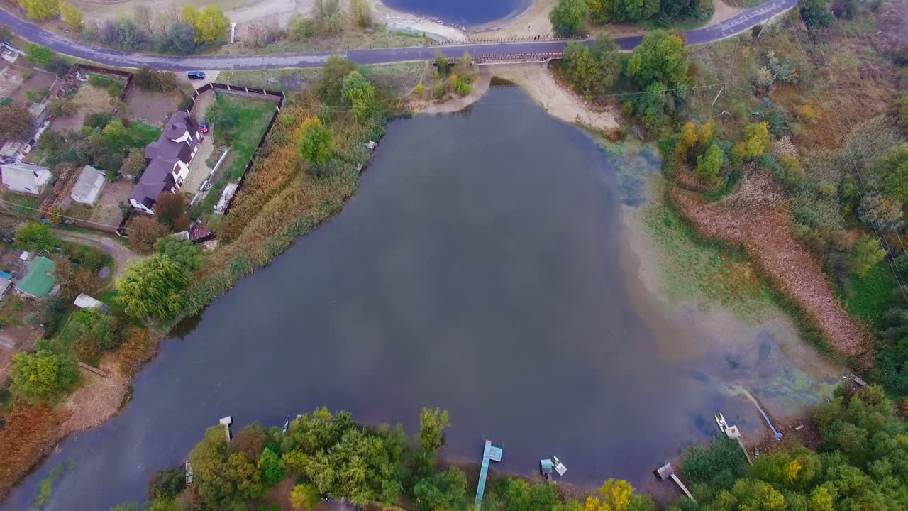 Aerial view of a lake, river, and surrounding landscape in autumn