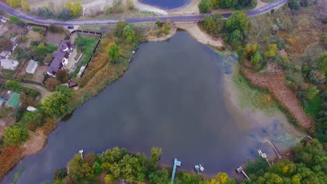 aerial view of a lake, river, and surrounding landscape in autumn