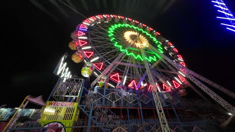 spinning empty ferris wheels building pan shot day maharashtra india close up covid lockdown night wide angle