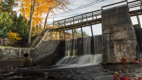 time lapse of alton mill waterfall flowing during fall in ontario