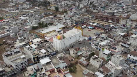 Aerial-pulls-out:-Yellow-Mayan-Church-in-San-Andres-Xecul,-Guatemala
