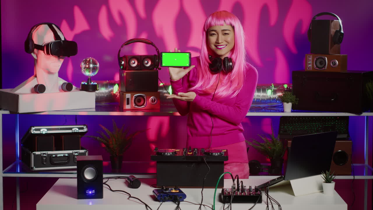 Woman with Pink Hair and Green Screen Phone in DJ Studio