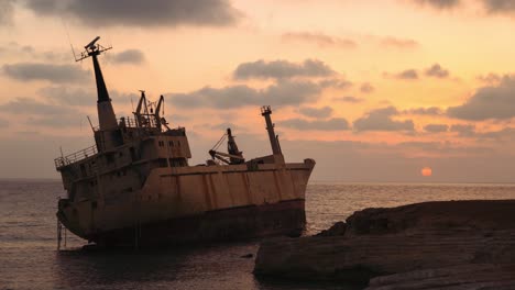 Rusty-EDRO-III-Shipwreck-by-Paphos-coast,-Cyprus-at-golden-hours-of-sunset,-timelapse