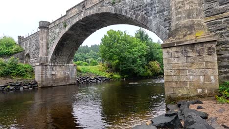 a serene stone bridge spans a tranquil river