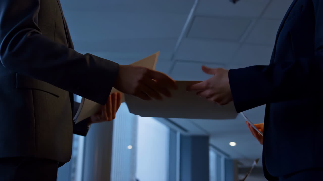 Business Professionals Exchanging Documents