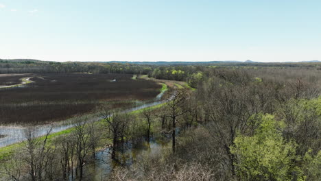 bell slough wildlife area with winding river and lush greenery, sunny day, aerial view