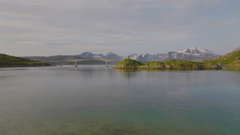 Beautiful-Aerial-Sommaroya-Island-Bridge,-seagulls-flying.-Spring