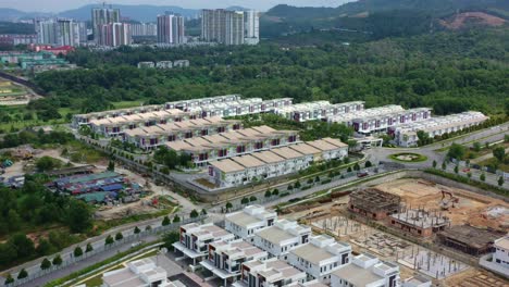 aerial views from a drone flyover reveal the semanja kajang project, a residential neighborhood featuring rows of semi-detached houses under construction by yuwang group, malaysia, southeast asia