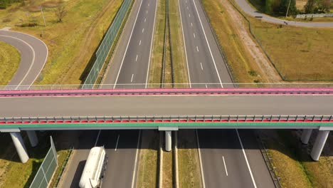 traffic of cars and trucks on the freeway in summer day - top view shot