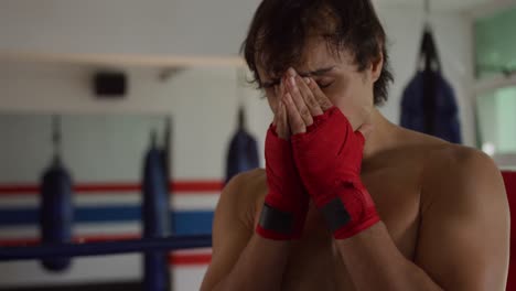 thoughtful caucasian man in boxing ring