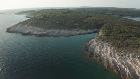 aerial shot of a small lagoon at cape kamenjak, drone dollies in to reveal more details