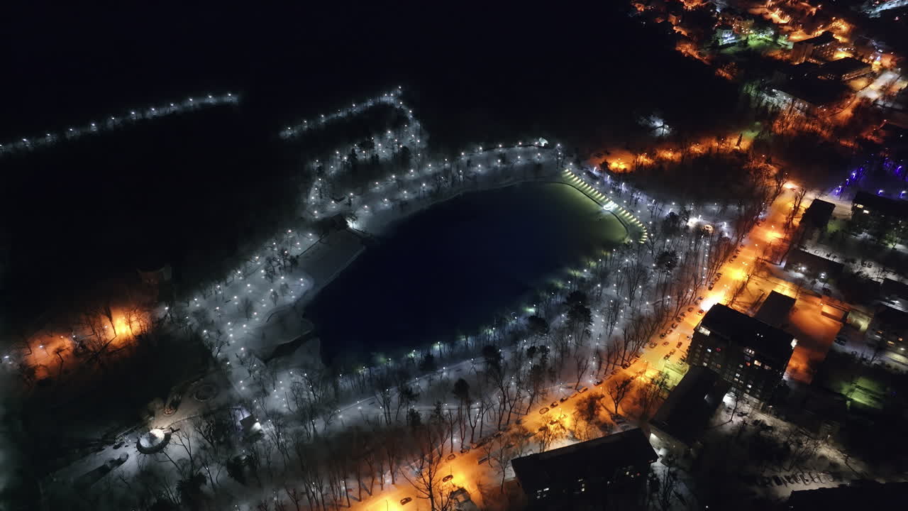 Aerial drone view of Chisinau city covered in snow at night, blue hour. Moldova
