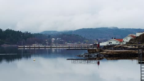 quiet fjord scene with houses and misty forest in havstensfjorden, ljungskile