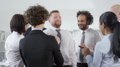group of businesspeople playing trust game in office