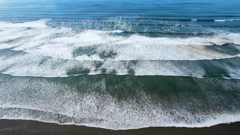 4K-aerial-drone-shot-looking-down-on-ocean-tide-at-Seaside,-Oregon-beach