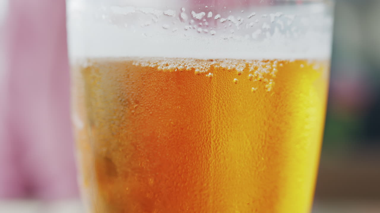 Close up of bubbles forming into foam in a beer glass