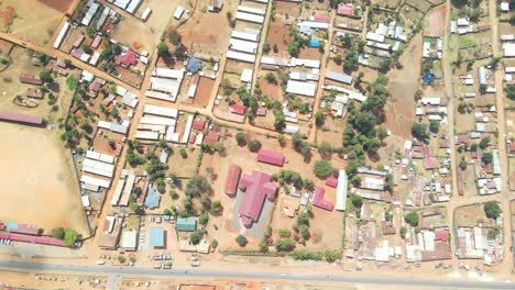 urban-setting-with-unassuming-buildings-and-poor-roads-in-Kenya,-Africa