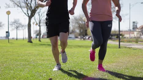 cropped shot of young couple running in parkland.