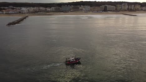 Fishing-Boat-on-Tropical-Costa-da-Caparica,-Portugal---Aerial-Drone-View