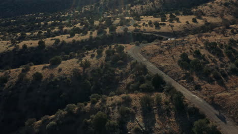 Aerial-circling-remote-forest-service-road-in-New-Mexico-wilderness,-4K