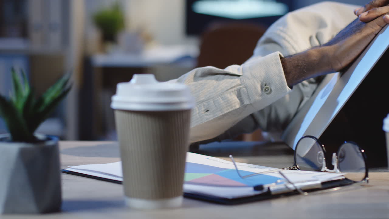 Close Up View Of Tired Office Worker Sleeping On The Table With Laptop Over Head In The Office At Night