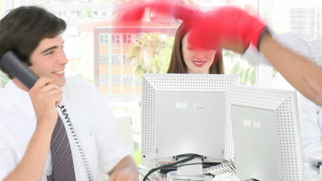 Businessman-in-office-messing-with-boxing-gloves