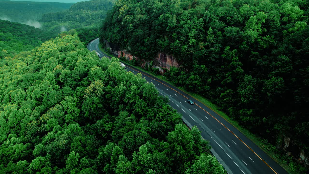 Semi truck drivers transporting cargo along I-24 through Monteagle, Tennessee, heavy-duty logistics operations and supply chain