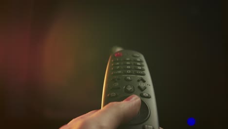 hand holding tv remote, watching tv