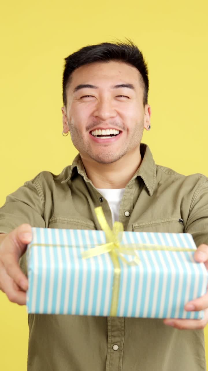Smiling Asian Man with a Gift