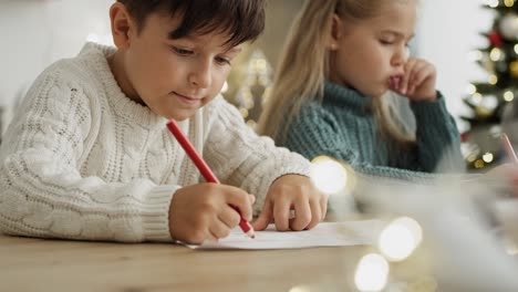 close up video of little boy writing a letter to santa claus